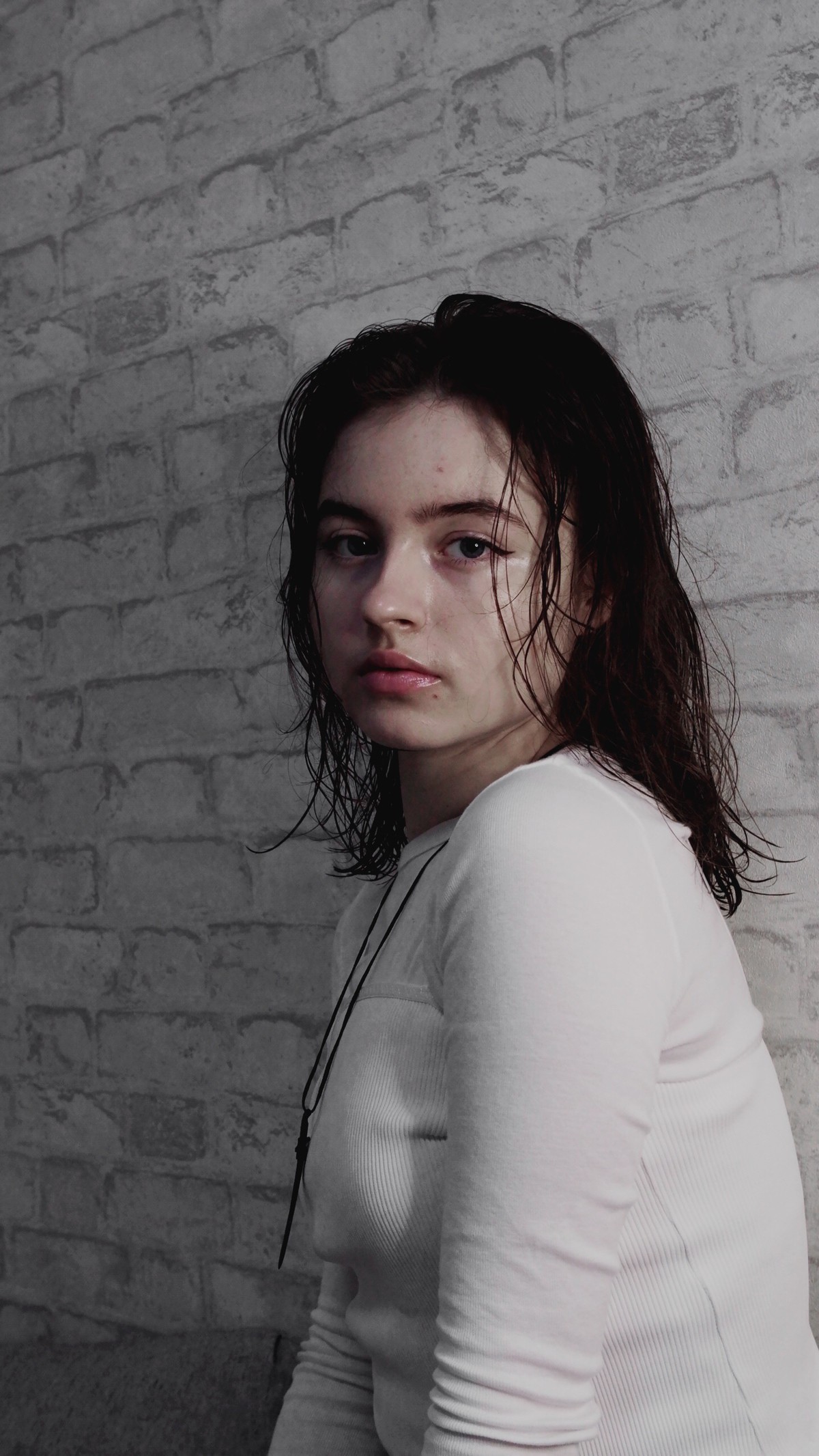 Maya Clars, Maya Clars, white, grey, bricks, white bricks, music, song, Spotify photo, ideas for photos, photo ideas, white wall, white clothes, brown hair, sword necklace, new singer, music 2022, sad songs, I’m sorry, sorry not sorry 